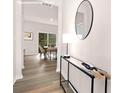 Inviting hallway with modern console table, mirror, and a glimpse of the dining area at 11135 Cardinal Creek Ave, Charlotte, NC 28215