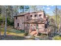 Two-story home with a sloped roof and wooden deck in a wooded setting at 1119 Palmyra Dr, Tega Cay, SC 29708