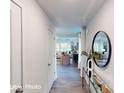 Inviting entryway with wood floors and a decorative mirror, leading to the living room at 11216 Cardinal Creek Ave, Charlotte, NC 28215