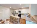 Bright kitchen featuring white cabinets, stainless steel appliances, and a center island at 11216 Cardinal Creek Ave, Charlotte, NC 28215