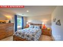 Cozy bedroom features neutral walls, plush carpet, and ample natural light at 11221 Cardinal Creek Ave, Charlotte, NC 28215