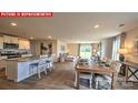 Open floorplan showcasing kitchen island, dining area, and comfortable living space at 11221 Cardinal Creek Ave, Charlotte, NC 28215