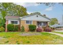 Quaint brick home featuring lovely landscaping and a well-manicured lawn at 1400 Russell Ave, Charlotte, NC 28216