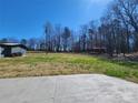 Large backyard with mature trees, concrete patio, and storage shed offer endless possibilities at 1730 Martin Rd, Kings Mountain, NC 28086