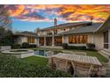 Stunning backyard features a pool, outdoor dining area, and manicured lawn, perfect for relaxation and entertaining at 19117 Davidson Concord Rd, Davidson, NC 28036