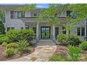 Inviting front entrance with a stone walkway, manicured landscaping, and a stylish door at 19117 Davidson Concord Rd, Davidson, NC 28036