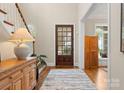 Elegant foyer featuring hardwood floors, a wood door, and views of the front yard at 21311 Baltic Dr, Cornelius, NC 28031