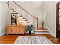Inviting foyer with hardwood floors, staircase, stylish decor, and a round window at 21311 Baltic Dr, Cornelius, NC 28031