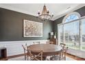 Elegant dining room features a large round table, chandelier, and bright window at 2508 Shaggy Bark Ct, Belmont, NC 28012