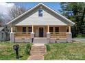 Charming home featuring a welcoming front porch with railings and a well-manicured lawn at 257 3Rd Se Ave, Hickory, NC 28602