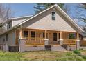 Attractive home featuring a cozy front porch with beautiful wood accents and a manicured lawn at 257 3Rd Se Ave, Hickory, NC 28602