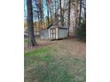 Outdoor storage shed in backyard with wooded surroundings and easy access for tools and equipment at 3748 Caribou Dr, Sherrills Ford, NC 28673