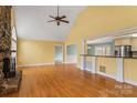 Bright living room with wood floors, stone fireplace, open layout, and lots of natural light at 3772 Sandy Ford Rd, Hickory, NC 28602