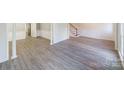 Open-concept living room showcasing modern floors, wainscoting, and a staircase, perfect for entertaining guests at 4351 Woodglen Ln, Charlotte, NC 28226
