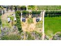 Aerial shot of two homes, showcasing their placement amidst green fields and tree-lined boundaries at 437 Cedar Grove Rd, Clover, SC 29710