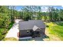 An aerial view of the home shows a well-maintained roof, complemented by lush greenery and a long driveway at 437 Cedar Grove Rd, Clover, SC 29710