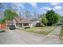 Exterior showing a charming home with well-manicured lawn and mature trees at 4501 Brandie Glen Rd, Charlotte, NC 28269