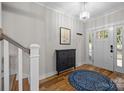 Bright foyer featuring hardwood floors, elegant lighting, and stylish decor at 463 Lake Wylie Rd, Belmont, NC 28012