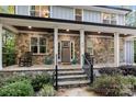 Inviting front porch with stone columns, rocking chairs, and well-maintained landscaping at 463 Lake Wylie Rd, Belmont, NC 28012