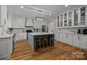 Spacious kitchen featuring a large center island with seating, white cabinets, and modern appliances at 463 Lake Wylie Rd, Belmont, NC 28012