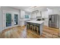 Bright kitchen with white cabinets, center island with seating, and stainless steel appliances at 463 Lake Wylie Rd, Belmont, NC 28012