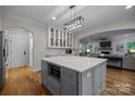 Well-lit kitchen with a large island, stainless steel microwave, and hardwood floors at 463 Lake Wylie Rd, Belmont, NC 28012
