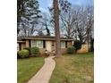 Inviting single-story brick home with well-maintained lawn, landscaping, and classic design elements at 4805 Horizon Cir, Charlotte, NC 28215