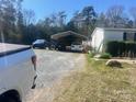 Gravel driveway with covered parking area, offering ample space for multiple vehicles at 5320 Golden Pond Dr, York, SC 29745