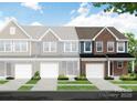 New construction townhome with brick facade, single car garage, and manicured lawn at 6282 Tea Olive Dr # Lot 236, Harrisburg, NC 28075