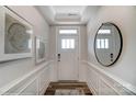 Inviting hallway with decorative trim, mirror, and a front door with sidelights at 6282 Tea Olive Dr # Lot 236, Harrisburg, NC 28075