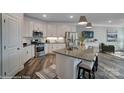 Modern kitchen with stainless steel appliances, island with seating, and stylish countertops at 6282 Tea Olive Dr # Lot 236, Harrisburg, NC 28075