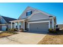 Inviting home featuring a gray garage door, manicured lawn, and a cozy covered porch at 758 Latrobe Dr, Iron Station, NC 28080