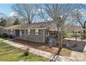 Brick home featuring a carport, landscaped yard, and a welcoming, traditional aesthetic at 839 Oak Grove Rd, Kings Mountain, NC 28086