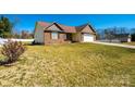 Traditional home featuring a blend of brick and siding, complemented by a well-kept lawn at 9027 Mccray Farms Dr, Hickory, NC 28601