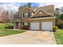 Charming two-story brick home featuring a two-car garage, and landscaped yard at 9391 Leyton Dr, Harrisburg, NC 28075