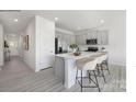 Modern kitchen with gray cabinets, stainless steel appliances, and a large island with bar seating at 112 Parker Claire Ln, Kings Mountain, NC 28086