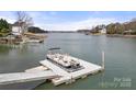 Close view of private boat dock, providing easy access to the tranquil lake waters surrounded by lush landscapes at 116 Cottage Grove Ln, Mooresville, NC 28117