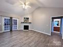 Bright living room features a fireplace, modern ceiling fan, and sliding glass doors to the outdoors at 145 Mcbride Dr, Rockwell, NC 28138