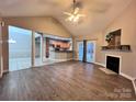 Open-concept living room with fireplace flows seamlessly into kitchen and dining area at 145 Mcbride Dr, Rockwell, NC 28138