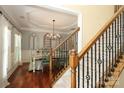 Elegant dining room with hardwood floors, decorative wainscoting, and a stylish chandelier at 1800 Robbins Meadows Dr, Waxhaw, NC 28173