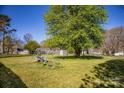 Large backyard featuring a play set, shed, and mature trees at 209 W Church St, China Grove, NC 28023