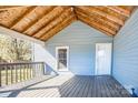 Cozy covered front porch with wood floors and railing, perfect for relaxing at 209 W Church St, China Grove, NC 28023