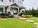 Two-story home boasting a well-manicured front lawn, welcoming porch, and beautiful curb appeal at 2150 Paddlers Cove Dr, Clover, SC 29710