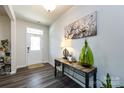 Welcoming entryway featuring new floors, a decorative table with lamp, and art on the walls at 3100 Cheyney Park Dr, Charlotte, NC 28269