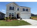 Two-story home featuring a well-manicured lawn, two-car garage, and inviting front entrance at 317 Maidstone Dr # 57, Monroe, NC 28110