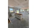 Open-concept kitchen flowing into the living area, featuring white cabinets and lots of natural light at 317 Maidstone Dr # 57, Monroe, NC 28110