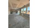 Large living area with multiple windows providing ample natural light, flowing into the kitchen at 317 Maidstone Dr # 57, Monroe, NC 28110