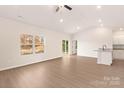 Bright living room with wood-look floors, ample natural light, and an open floor plan at 3246 Maple Ridge Dr, Gastonia, NC 28052