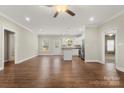 Bright and spacious living room with hardwood floors and views into the open kitchen at 325 East St, Heath Springs, SC 29058