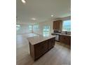 Open kitchen with island, stainless steel appliances, granite countertops, and wood cabinets that opens to living space at 346 Knotty Wood Dr # 71, Monroe, NC 28110